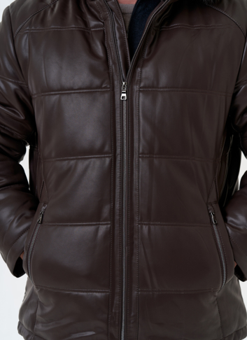 Пуховик из эко кожи с капюшоном из меха енота